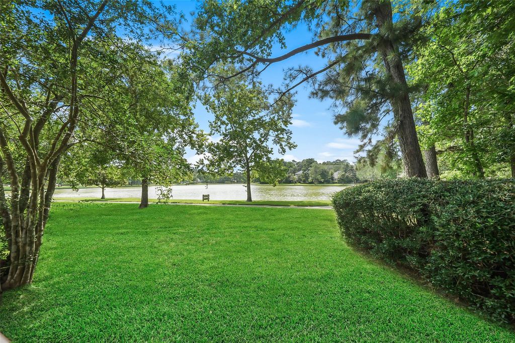 Backyard with mature trees and tranquil lake